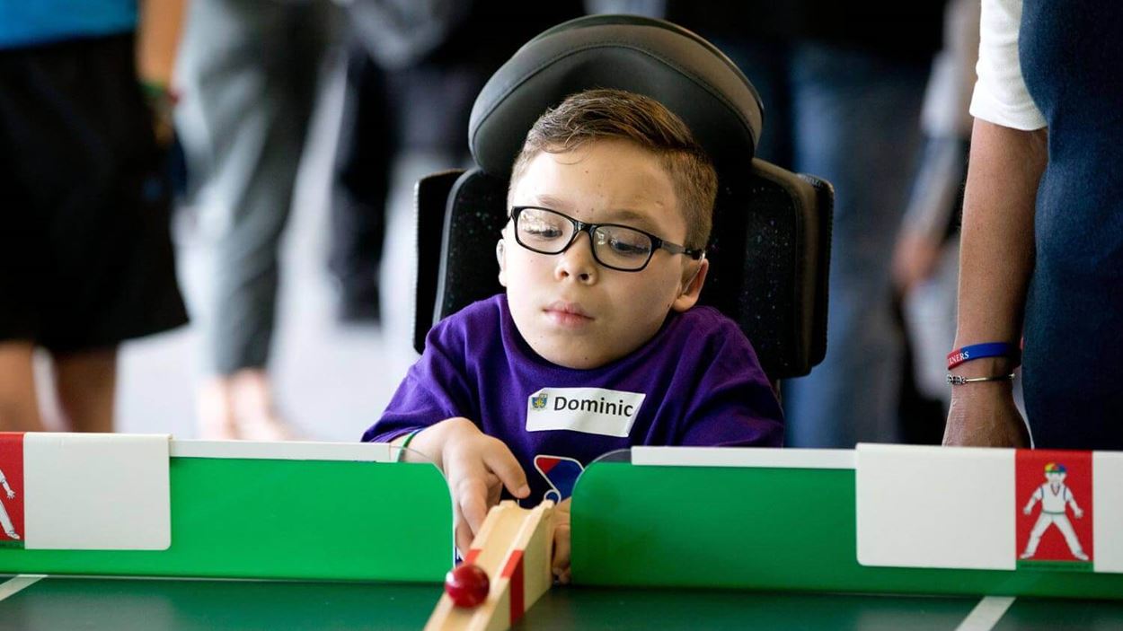 Dominic pitching the ball at the cricket table